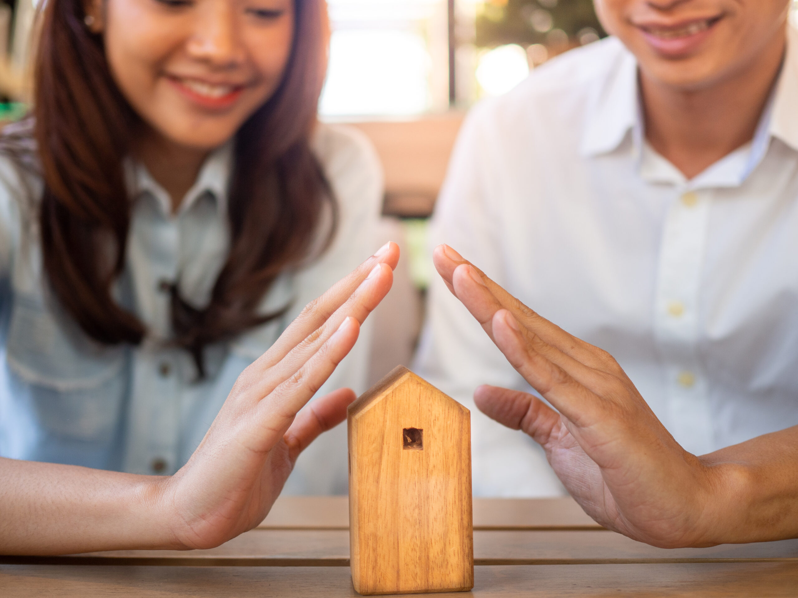 The beginning of the family life of happy couples in a new home. Insurance for property protection is home and health.